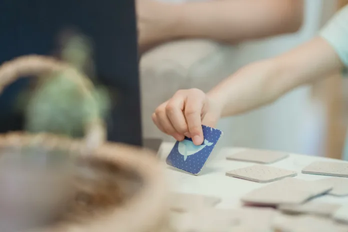 A kid s hand holding a blue card