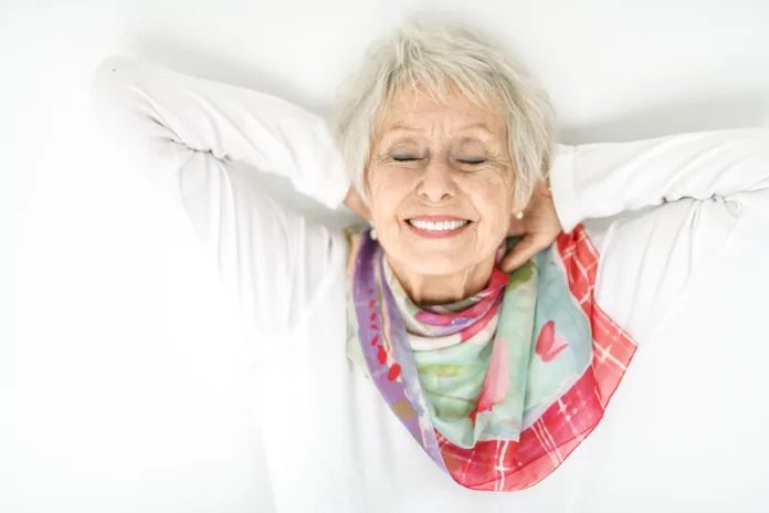 A senior lady posing on white background look like relaxing