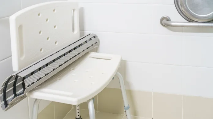 Non slip rubber bath mat on the plastic chair in hospital bathroom and shower