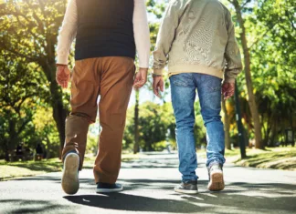 Toliko korakov dnevno naj bi naredili po 60. letu starosti Walking, park and back of men outdoors for wellness, fresh air and health in retirement. Friends, fitness and legs of people on path in nature to relax for training, exercise and cardio workout