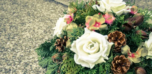 floral wreath decoration lying on the grave