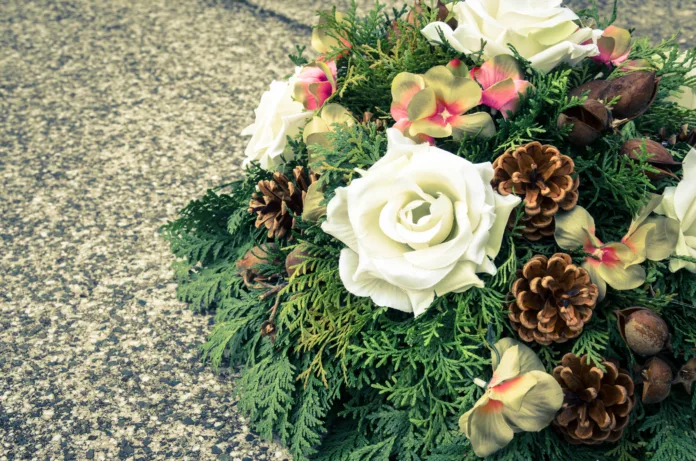 floral wreath decoration lying on the grave