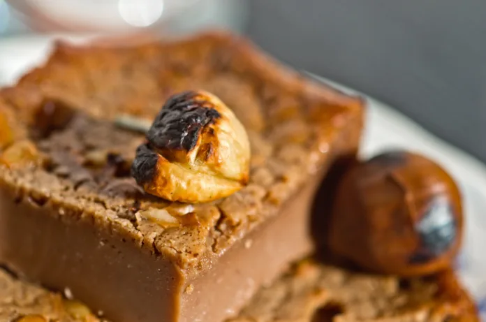 slices of sweet chestnut cake with nuts, pine nuts, hazelnuts, almonds and rosemary and a good glass of juice