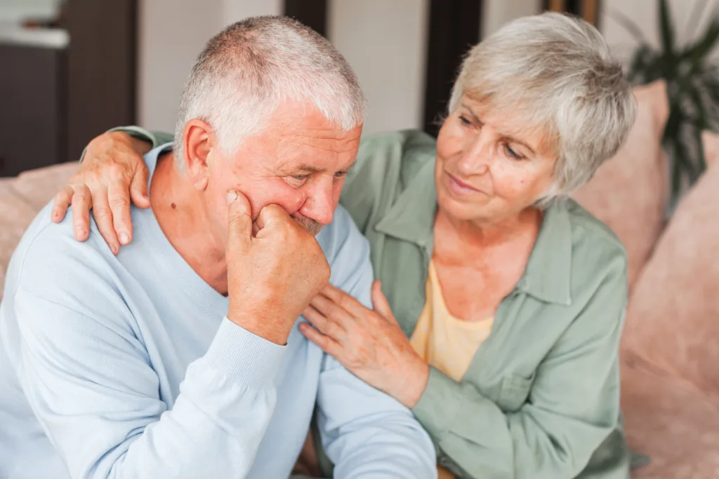 Worried middle aged woman embracing upset old man. Sensitive mature wife showing support, comforting depressed elder husband, experiencing grief