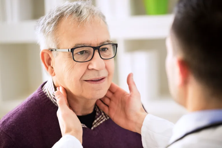 Doctor examining old patient lymph glands, throat inflammation