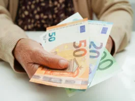 Retired elderly woman holding Euro banknotes money and worry about monthly expenses and treatment fee payment.