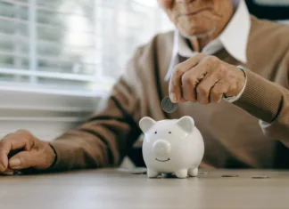 Ste preverili? Pokojnina za december nakazana danes Saving money investment for future. old man hand putting money coins in a piggy bank.investment, money, annuity insurance, saving for retirement and pension fund concept.Individual retirement account.