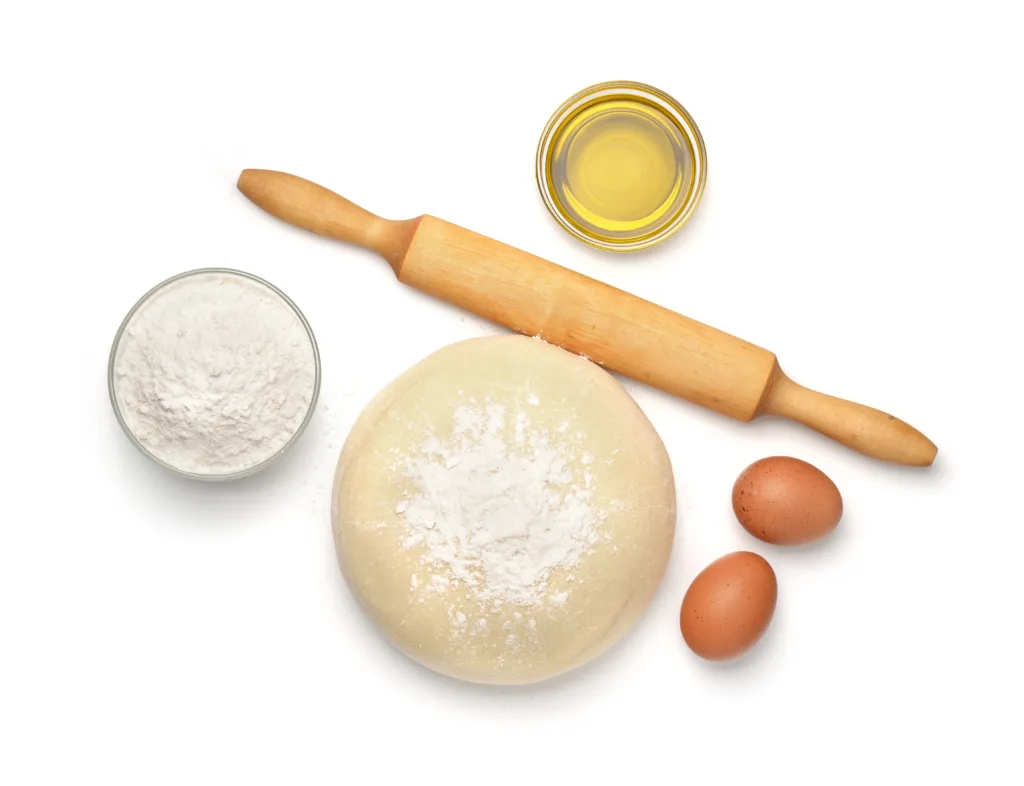 Top view of dough and baking  ingredients isolated on white