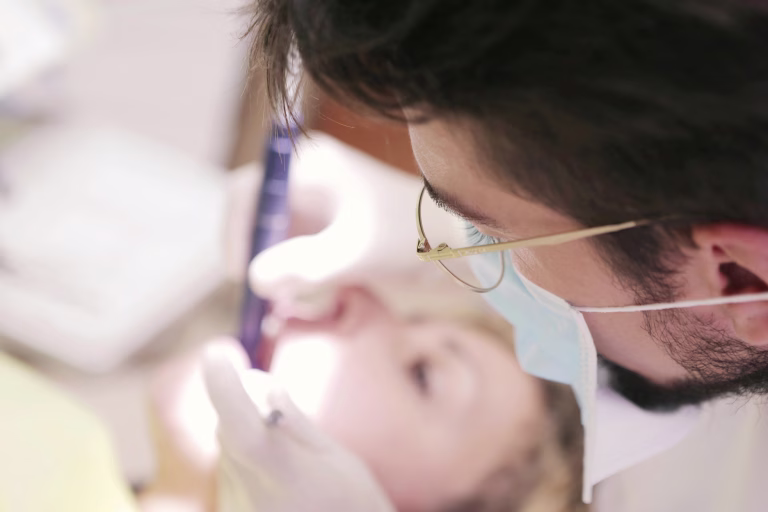 Male dentist working on woman s teeth