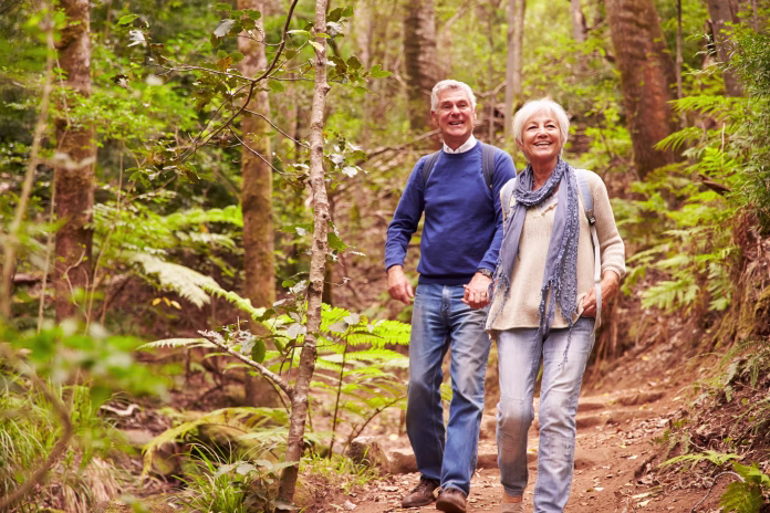 senior-couple-walking-together-in-a-forest-stockpack-istock Senior couple walking together in a forest