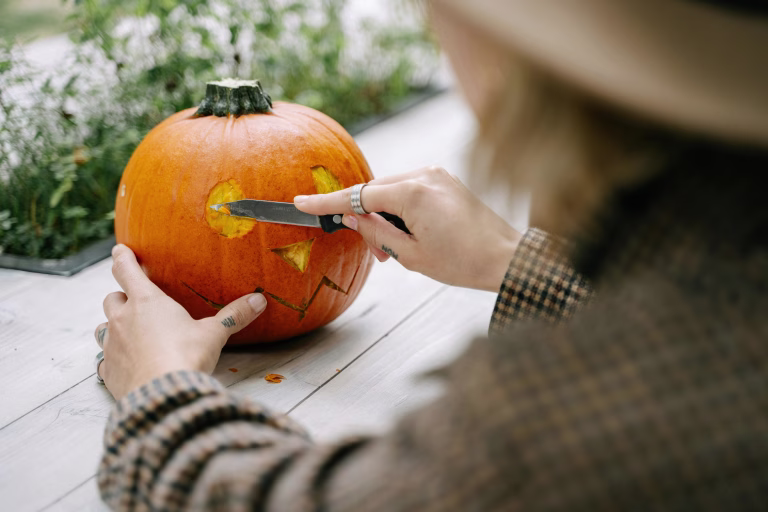 Person carving a pumpkin