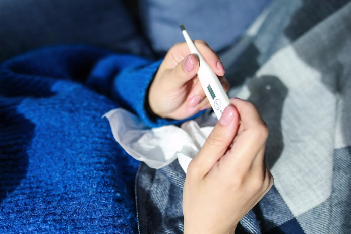 person-holding-thermometer-stockpack-pexels Person holding thermometer