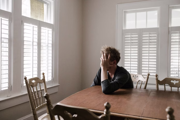 photo-of-man-leaning-on-wooden-table-stockpack-pexels Photo of man leaning on wooden table