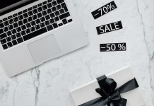 Izognite se pastem črnega petka Close up shot of a laptop beside discount tags