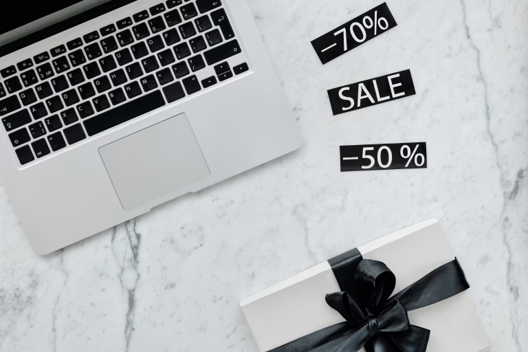 Close up shot of a laptop beside discount tags