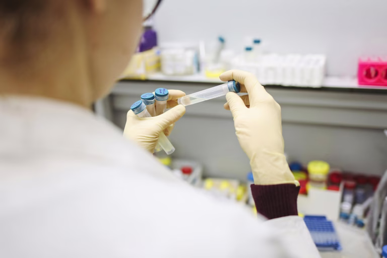 Person holding test tubes