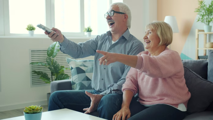 joyful-old-lady-is-watching-tv-with-handsome-elderly-husband-laughing-having-fun-enjoying-movie-at-home-entertainment-people-and-lifestyle-concept-stockpack-unsplash Joyful old lady is watching TV with handsome elderly husband laughing having fun enjoying movie at home. Entertainment, people and lifestyle concept.