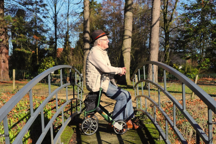 Resting on walker outside.