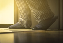 Kdaj je čas za nove copate? Adult man in pijamas walks to a bathroom at the night. Men's healths concept