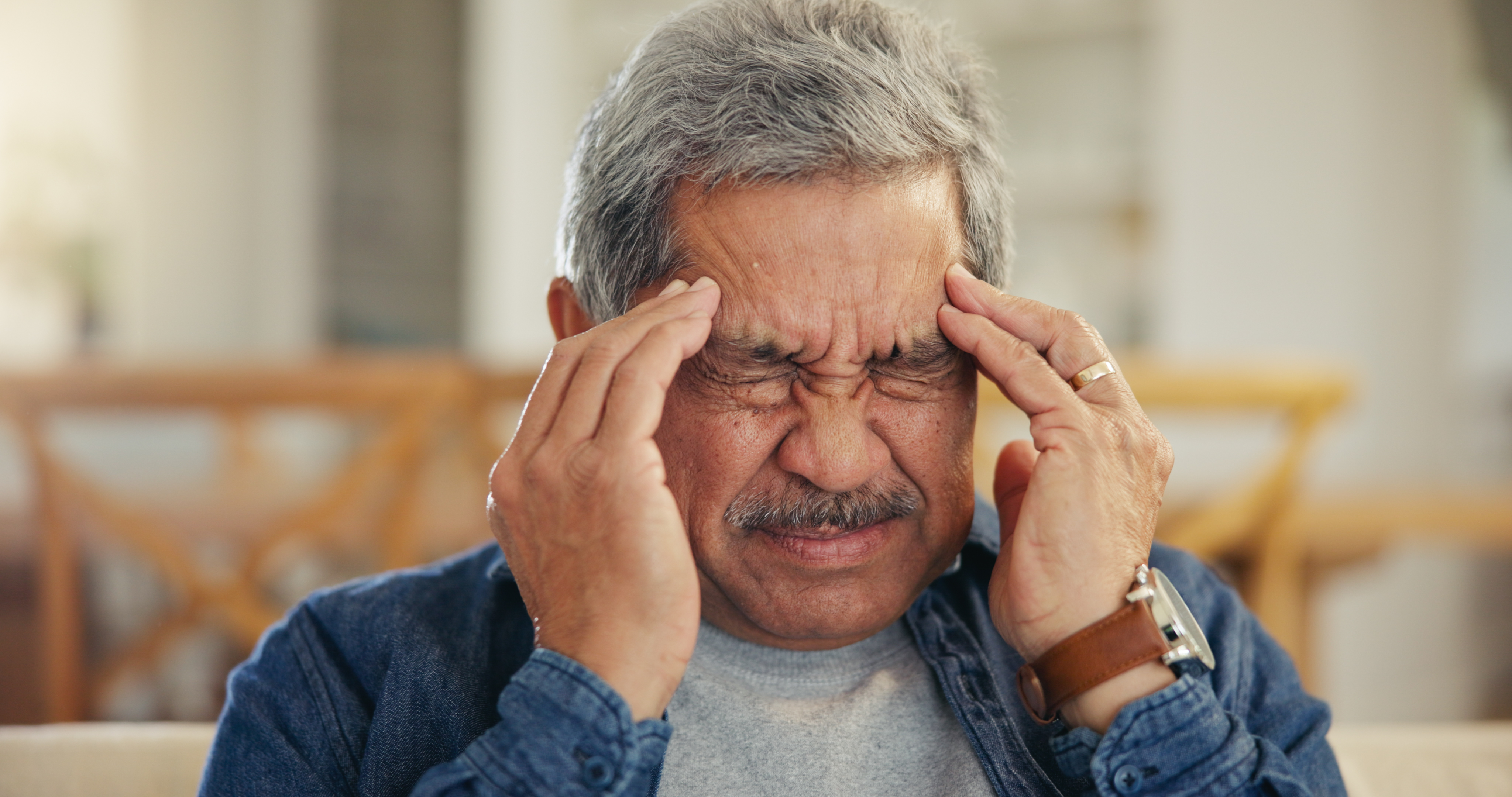 Headache, senior man and stress in home for mistake, mental health and brain fog in retirement. Face, tired and frustrated elderly guy with migraine, crisis and pain of vertigo, trauma and fatigue