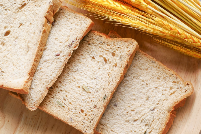 Sliced bread on brown wooden surface