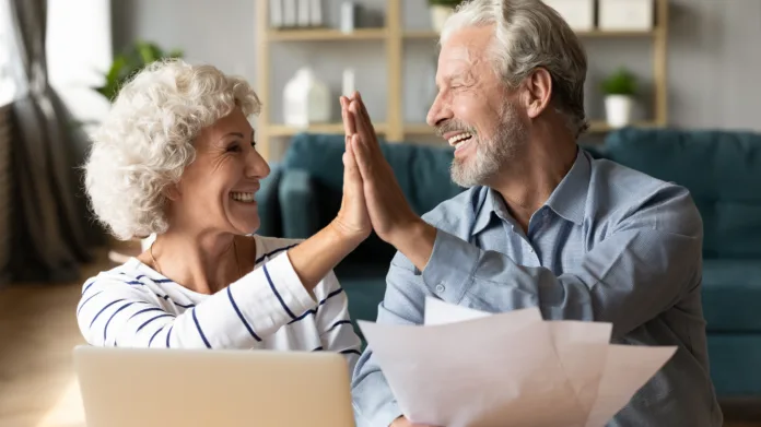 excited-older-couple-giving-high-five-mature-family-celebrating-success-checking-or-paying-domestic-bills-planning-budget-smiling-mature-man-holding-financial-documents-reading-good-news-stockpack-istock Excited older couple giving high five, mature family celebrating success, checking or paying domestic bills, planning budget, smiling mature man holding financial documents, reading good news