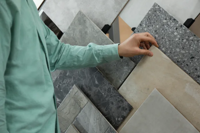 man-choosing-tile-among-different-samples-in-store-closeup-stockpack-istock Man choosing tile among different samples in store, closeup