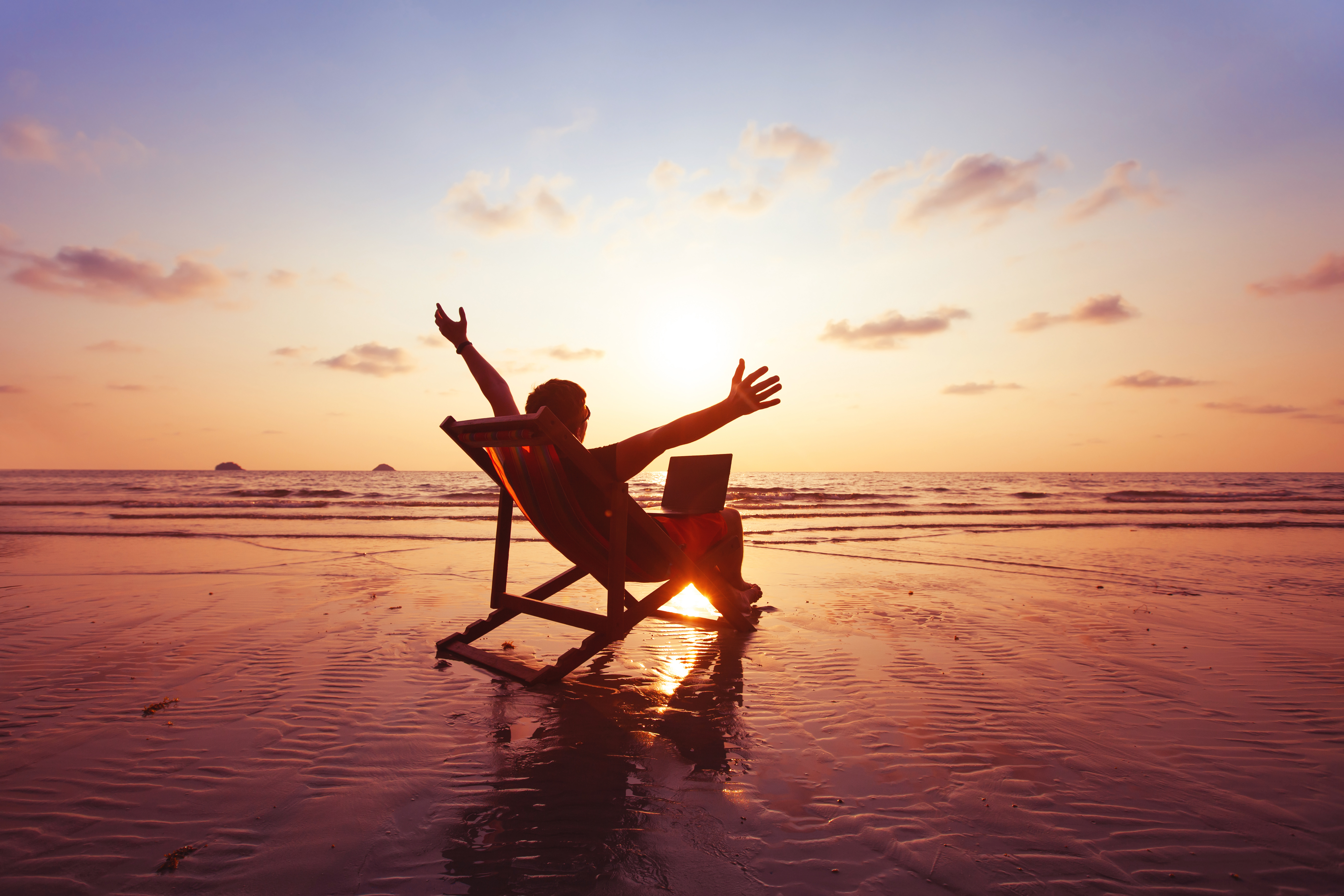 happy-freelancer-with-laptop-computer-working-on-the-beach-freelance-work-concept-dream-office-job-workplace-stockpack-istock happy freelancer with laptop computer working on the beach, freelance work concept, dream office job workplace