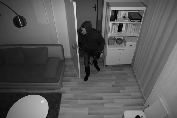 high-angle-view-of-a-robber-entering-in-vacant-house-stockpack-istock High Angle View Of A Robber Entering In Vacant House