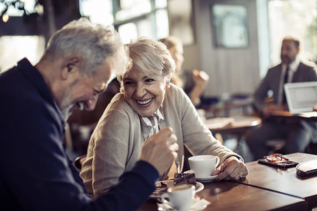 Close up of a happy senior couple having coffee in a cafe