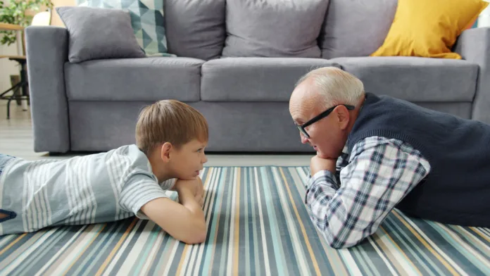 grandfather-and-grandson-lying-on-living-room-floor-stockpack-pexels Grandfather and grandson lying on living room floor
