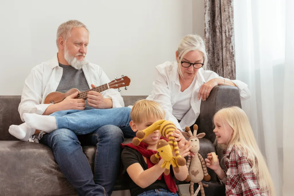 Grandparents playing with children in the living room