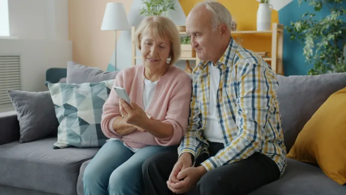 happy-people-elderly-couple-are-enjoying-social-media-using-smartphone-at-home-sitting-on-couch-together-modern-devices-technology-and-retirement-concept-stockpack-unsplash Happy people elderly couple are enjoying social media using smartphone at home sitting on couch together. Modern devices, technology and retirement concept.