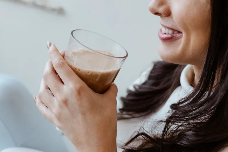 Woman drinking brown drink